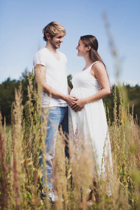 Paar bei Babybauch Shooting im Feld